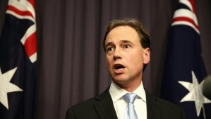 Greg hunt with flag looking mad